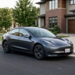 Tesla Model 3 parked at a modern American home with an EV charging setup.