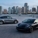 Tesla Model 3 and Tesla Model Y compared on a rooftop overlooking downtown Miami.